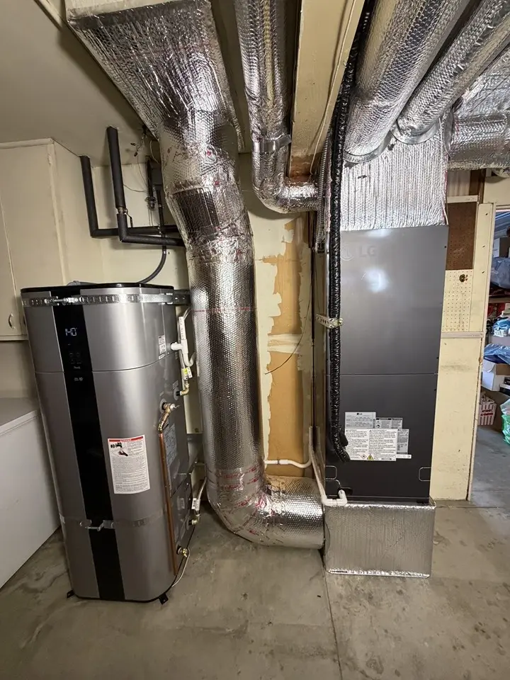 An existing gas water heater and furnace in a mechanical closet