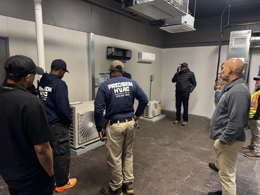 Contractors reviewing heat-pump equipment together